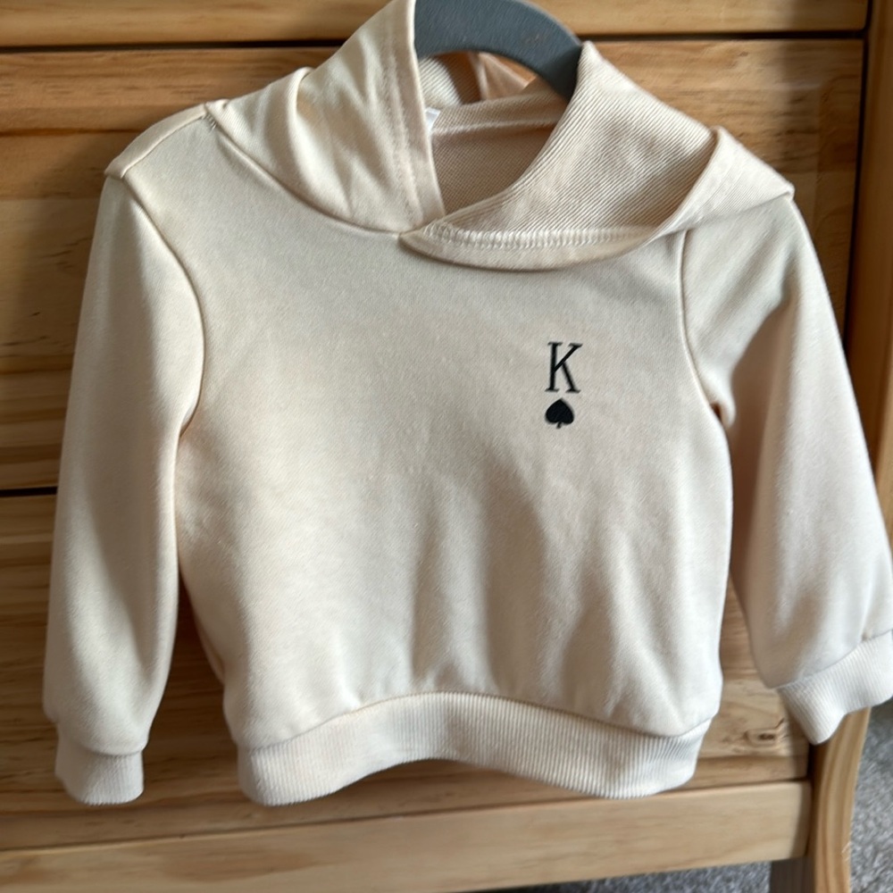 Cream and black baby hoodie with King graphics